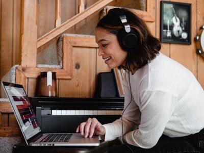 person with headphones at laptop